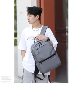 Detail view of durable gray waterproof nylon backpack with side pockets on male model