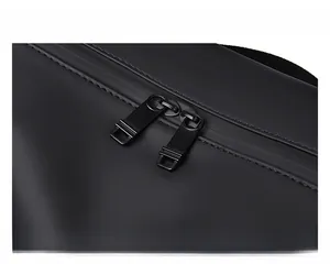 Detail of waterproof matte black fabric and durable double metal zippers on travel bag