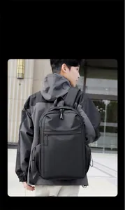 Detail view of water-resistant matte black backpack with drawstring side pockets and sleek zip