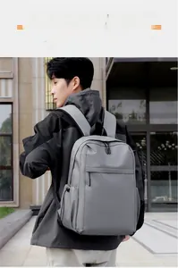 Detail view of grey nylon backpack with drawstring side pockets and dual zippers