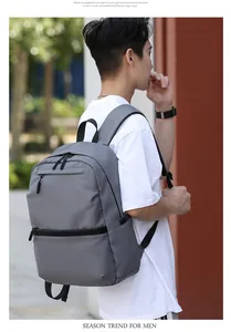 Outdoor shot of a grey business laptop backpack with smooth matte fabric and side profile