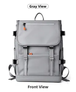 Close-up of a grey backpack front with orange zipper pulls and safety reflective strip