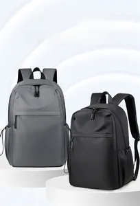 Detail view of grey and black nylon backpacks featuring side drawstrings and front pockets