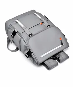 Close-up of grey backpack showing safety reflective strips and durable buckle details