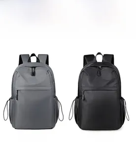 Front detail of gray and black nylon backpacks with side drawstring pockets and sleek zippers