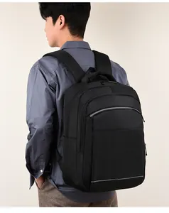 Close-up of black nylon backpack on male model showing side pocket and durable texture