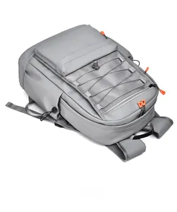 Top view of grey waterproof backpack showing sturdy handle and orange zipper details