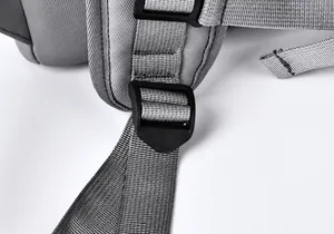 Detail of gray backpack strap showing heavy-duty adjustable buckle and nylon webbing