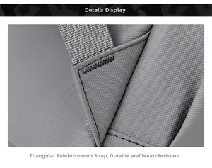 Close-up of triangular reinforced shoulder strap stitching on gray durable nylon backpack
