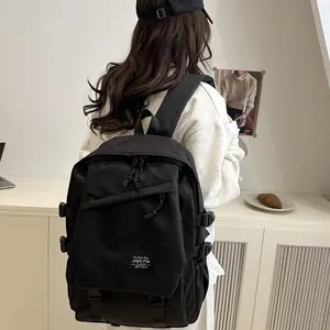 Minimalist black nylon backpack for students with large capacity and buckle details