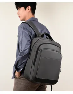 Deep grey minimalist backpack shown on model with durable fabric and multi-layer zippers