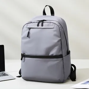 Modern light grey waterproof laptop backpack for business and travel in office setting