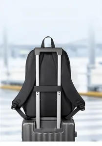 Close-up of black backpack luggage strap mounted on a silver suitcase handle for travel