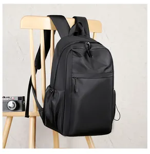 Detail of waterproof nylon backpack showing front zipper pocket and side drawstring pockets
