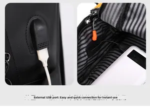 Detail of external USB charging port and interior cable on black business backpack