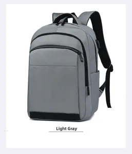 Detail of light grey nylon backpack showing front double zip pockets and side compartments