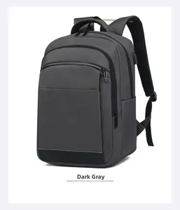 Detail view of water-resistant grey backpack showing USB port and padded shoulder straps