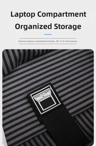 Detail view of internal 15.6-inch laptop compartment with striped lining and secure strap