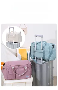 Quilted travel bags with trolley sleeves and shoulder straps in pink and blue