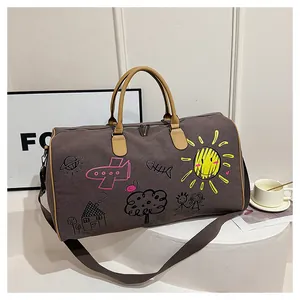 Macro detail of canvas travel bag with colorful graffiti art and leather handles
