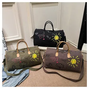 Three travel duffle bags with cartoon graffiti in black, army green and brown colors