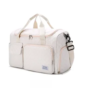 Detail view of large travel bag featuring quilted diamond pattern and side storage pocket