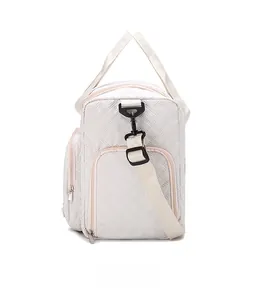Detail view of cream quilted travel bag with large capacity and separate shoe compartment