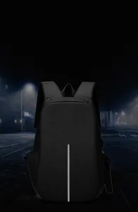 Detail view of a black backpack with a vertical silver reflective safety strip for night travel