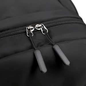 Close-up of black nylon backpack featuring durable double metal zippers and smooth texture