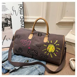 Detail of army style canvas travel bag with colorful graffiti and leather handles
