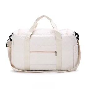 Back view of cream travel bag showing the quilted texture and flat zipper pocket