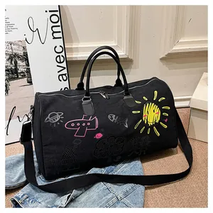 Detail of travel bag graffiti patterns including yellow sun and pink plane drawings