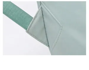 Detail of reinforced triangular stitching on the straps of a waterproof travel bag