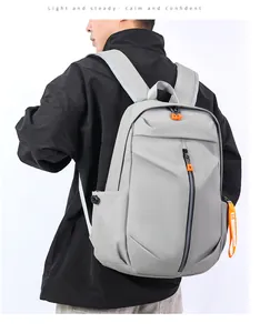 Detail view of grey waterproof laptop backpack with vibrant orange zipper pulls for men