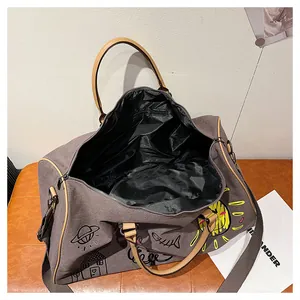 Detail view of graffiti canvas travel bag with inner lining and zipper pocket