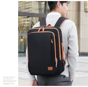 Detail view of water-resistant business backpack with side USB port and brown leather trim