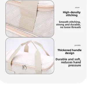 Detail of high-density stitching and thickened handle on cream quilted travel bag