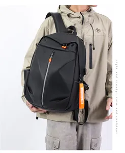 Detail of waterproof black backpack fabric with orange zipper pulls and stylish strap