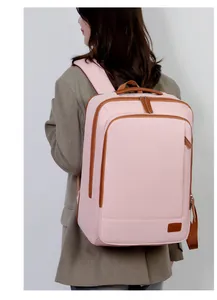 Rear view of light pink large capacity backpack with brown leather trim and padded straps