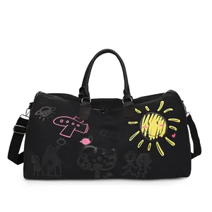 Black canvas travel bag featuring vibrant graffiti prints and adjustable shoulder straps