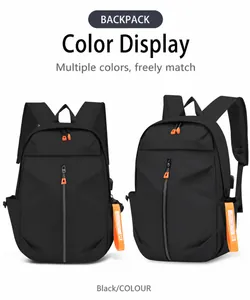 Detail of black waterproof backpack featuring side USB charging port and orange strap