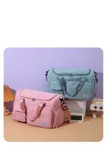 Detailed view of quilted travel bags in pink and blue featuring front zipper pockets