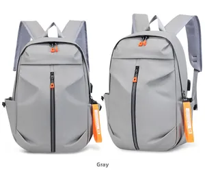 Grey multi-functional backpack with orange zippers, USB port, and breathable mesh straps