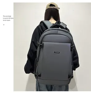Close-up of a large capacity waterproof business backpack in dark grey with metal logo