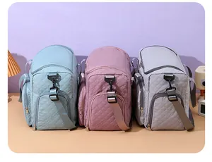 Three quilted nylon travel bags in blue pink and grey showing different color options