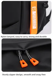 Detail of nylon lanyard and dual-zipper closure with orange handles on black backpack
