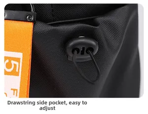 Detail of adjustable drawstring side pocket on a black nylon backpack with orange webbing