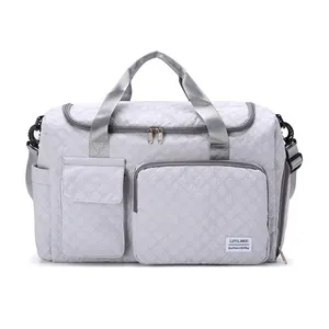 Quilted travel bag with large capacity, separate shoe compartment, and shoulder strap
