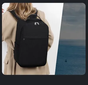 Waterproof black laptop backpack with silver zippers for business travel and commuting