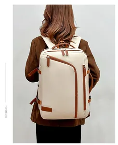 Detail view of stylish cream and brown laptop backpack with textured straps on model